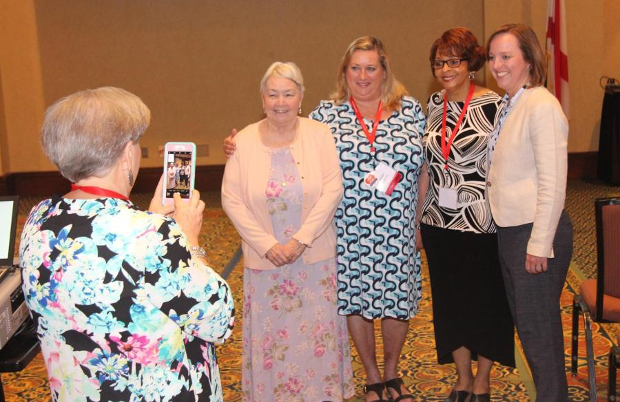 From left, Statewide Early Intervention Coordinator Betsy Prince takes a photo of Julie Beckett, Family Voices co-founder; Susan Colburn, state parent consultant; Melinda Davis, CRS assistant commissioner; and ADRS Commissioner Jane Elizabeth Burdeshaw