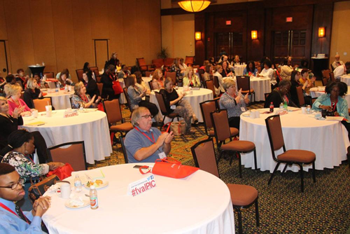The audience applauds during the general session feature speaker Julie Beckett